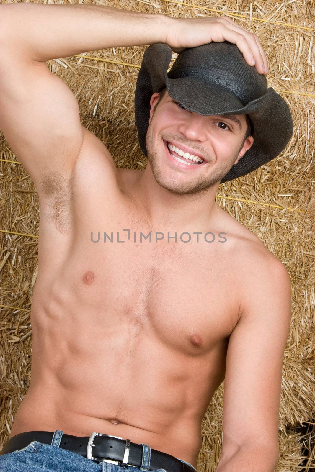 Smiling sexy shirtless cowboy