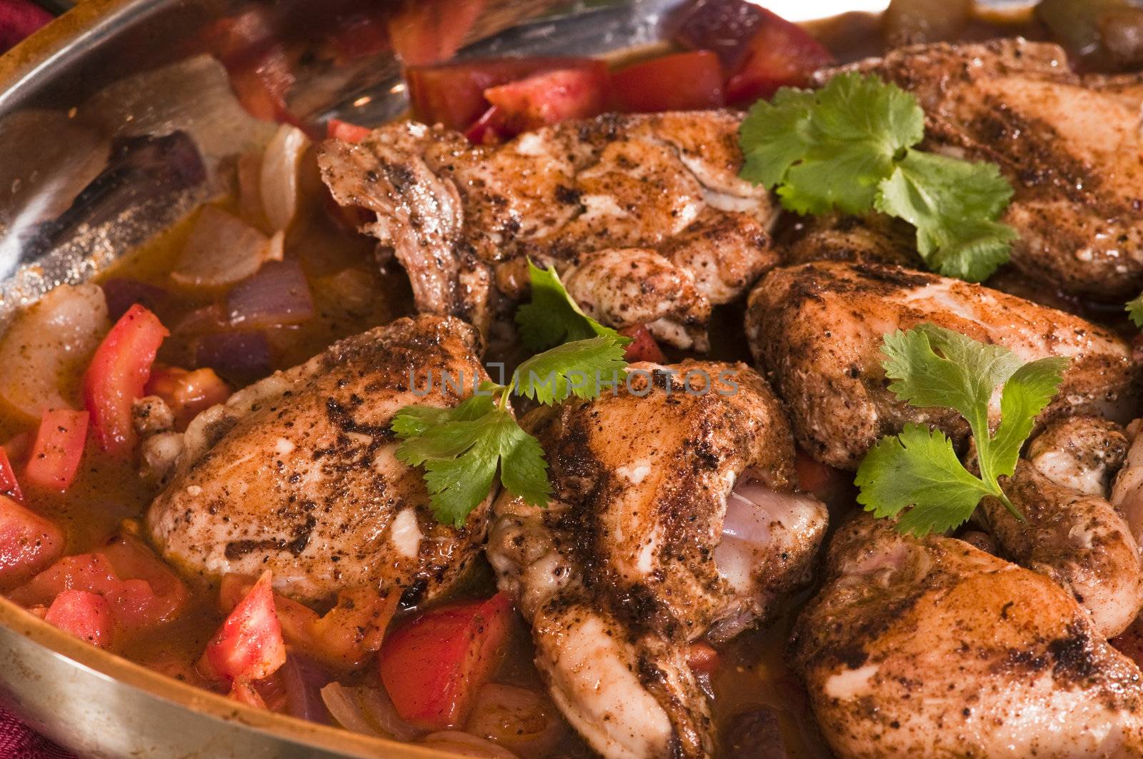 Seasoned chicken breasts with onions and tomatoes ready to be cooked