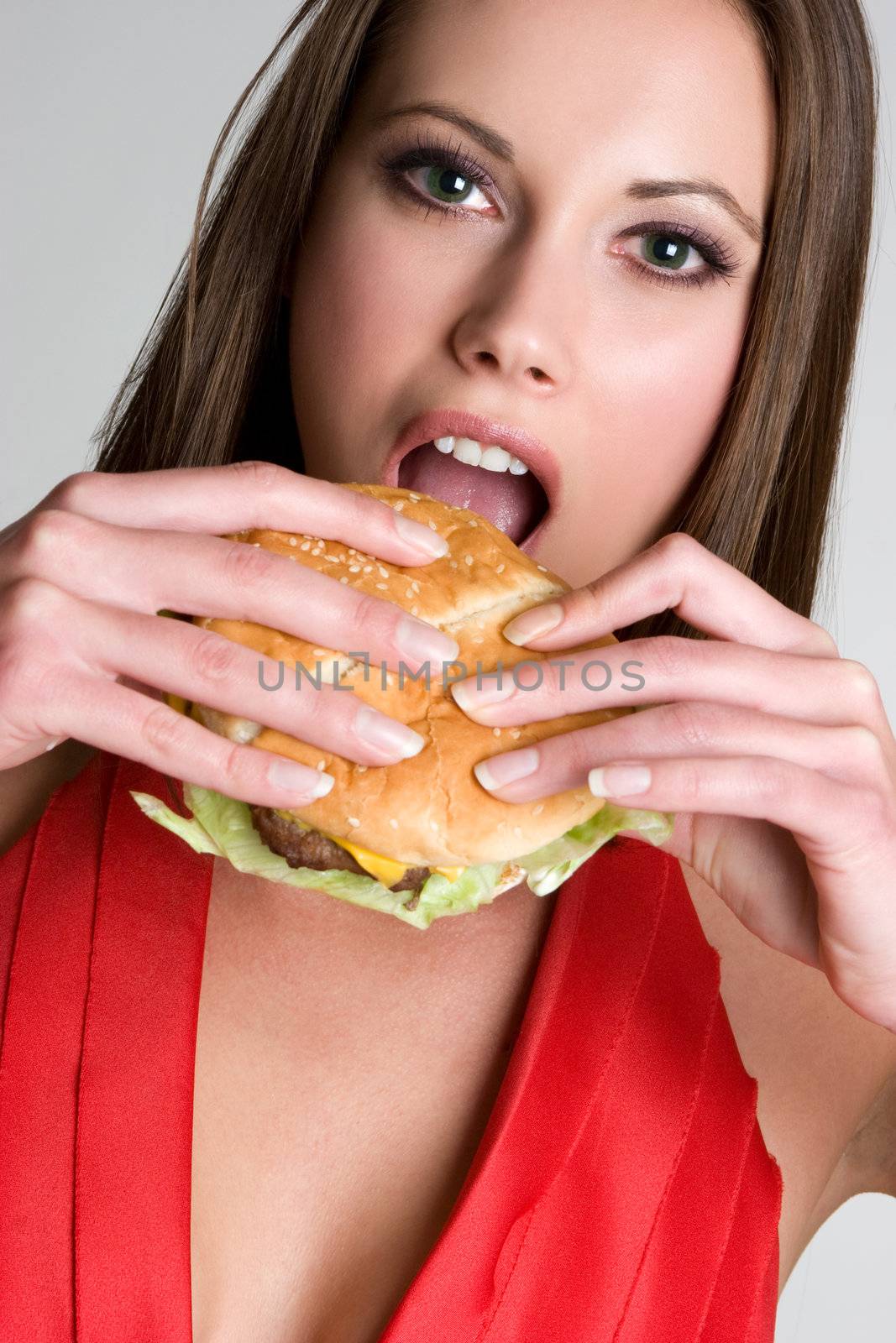 Beautiful woman eating hamburger