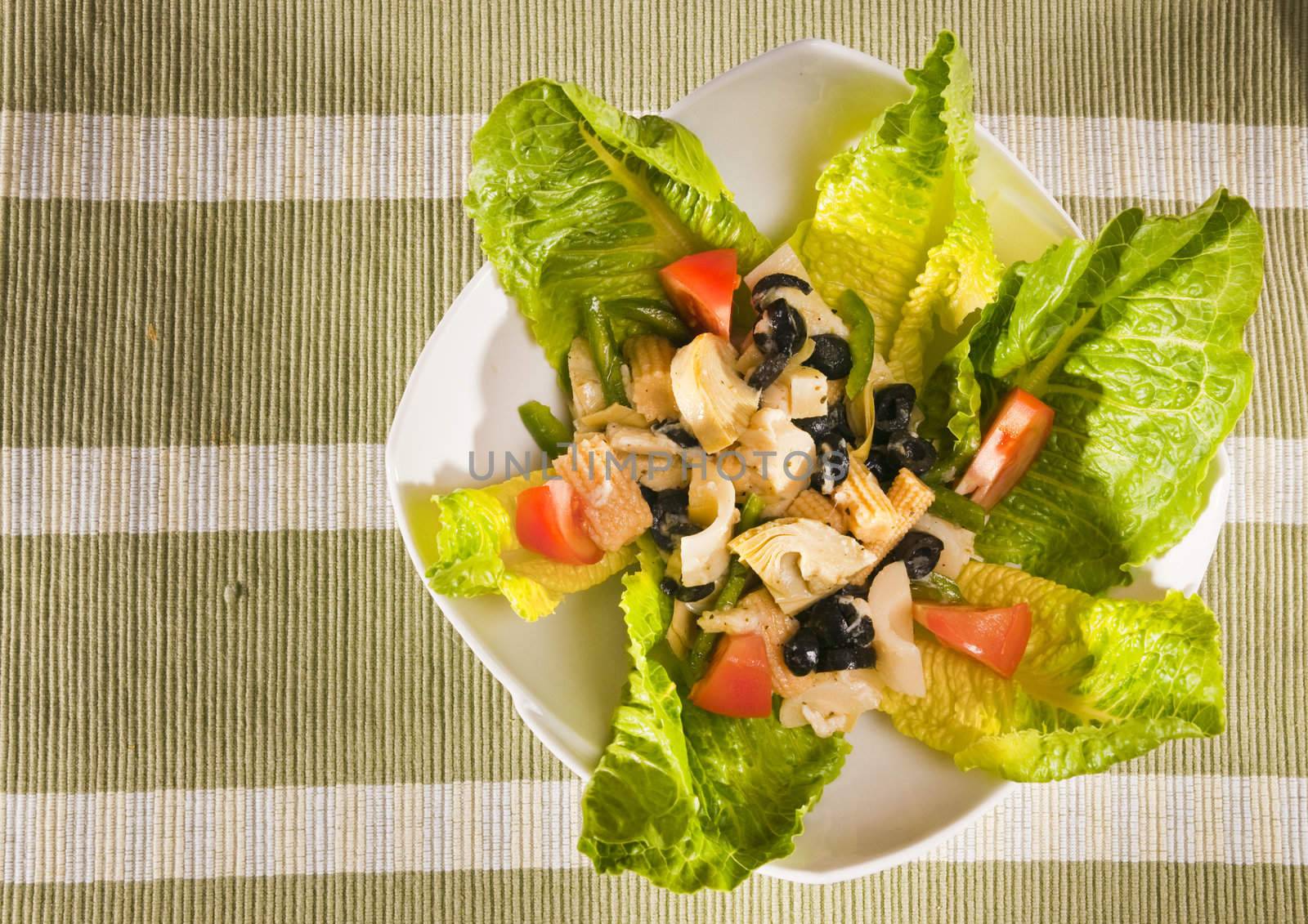 antipasto salad with lettuce, tomatoes, olives and corn