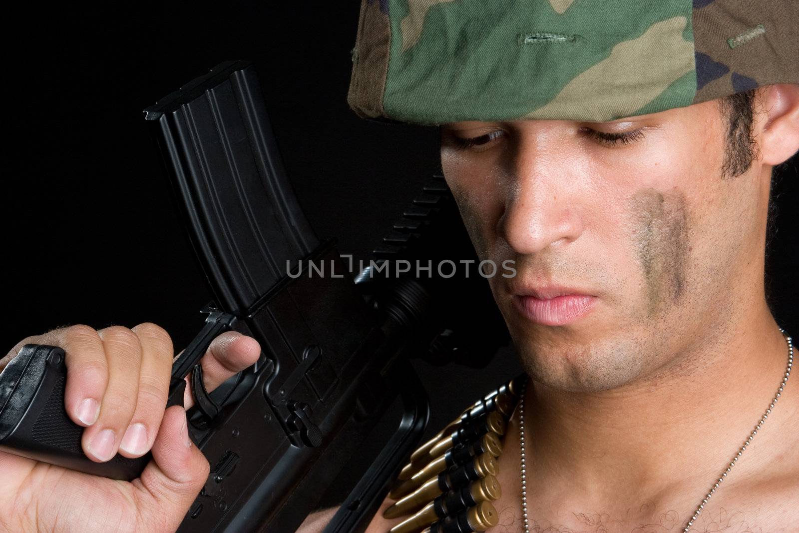 Military man holding gun