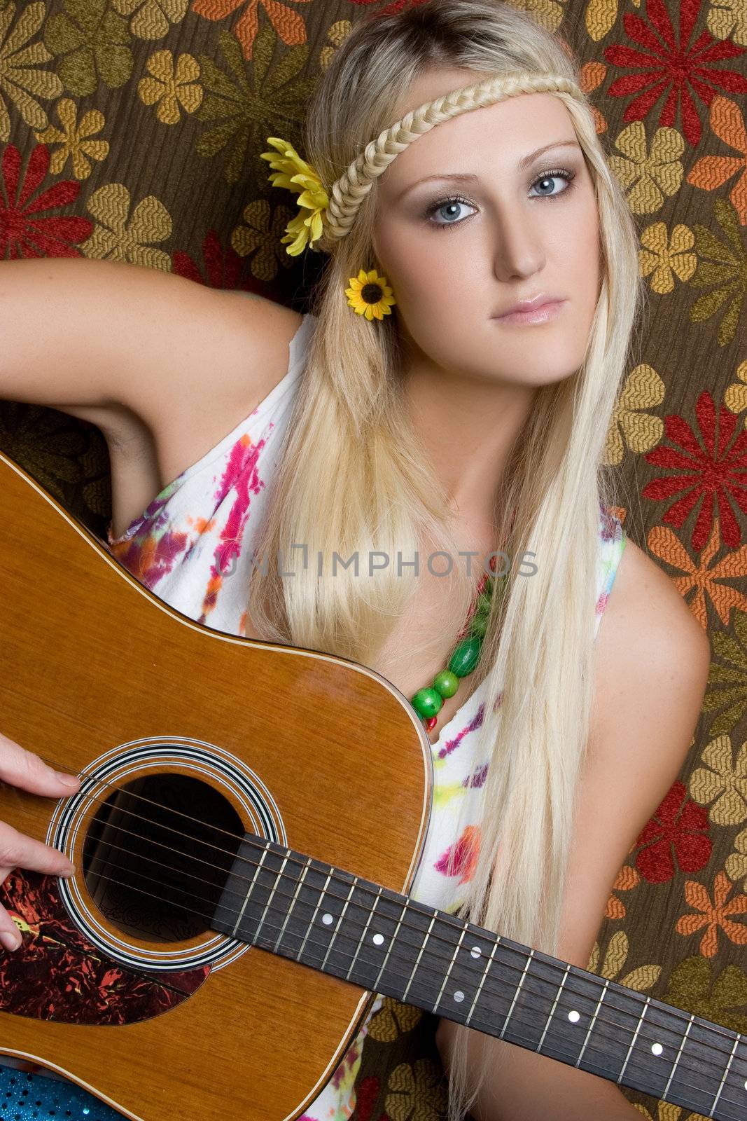 Beautiful blond hippie playing guitar