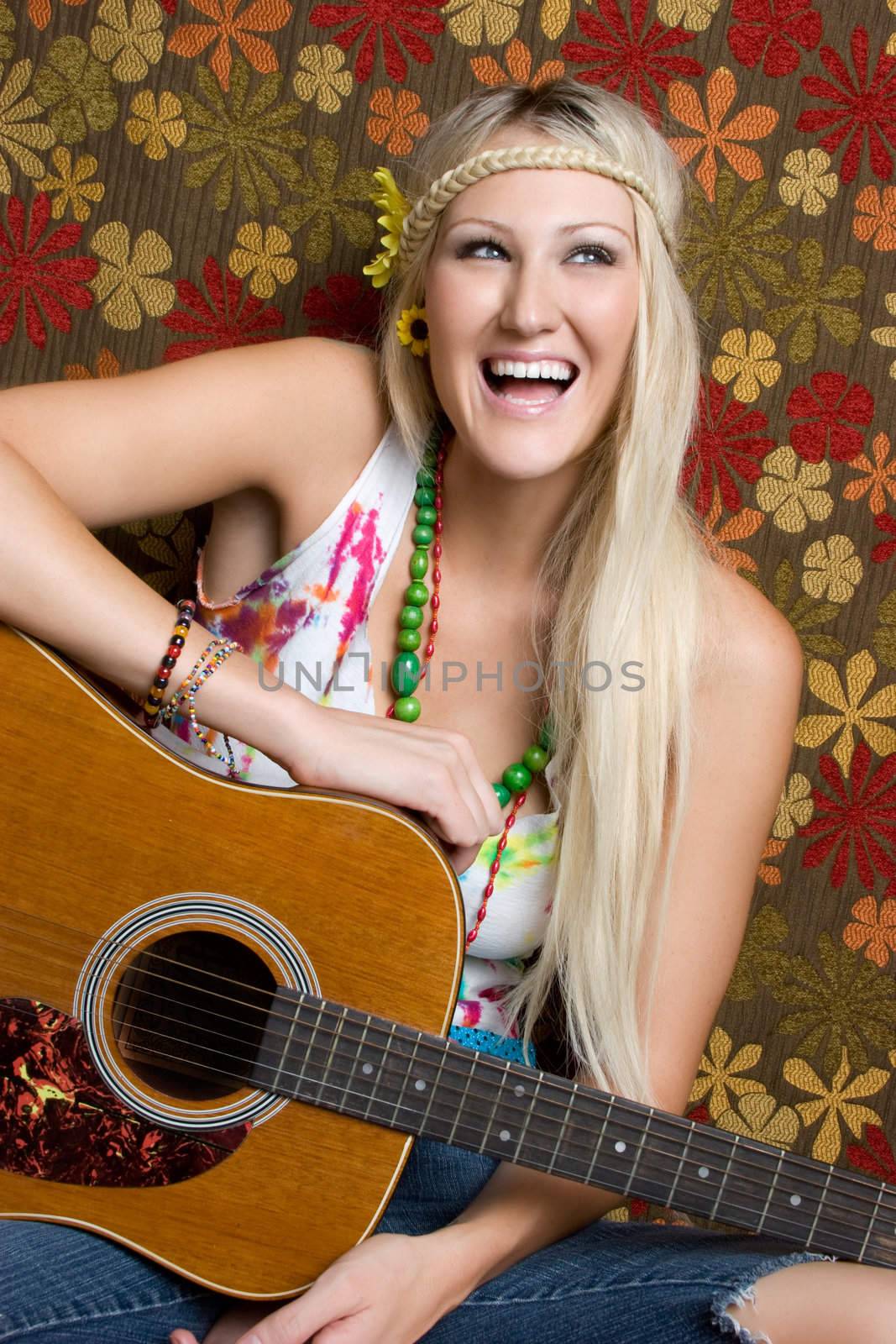Laughing hippie girl playing guitar