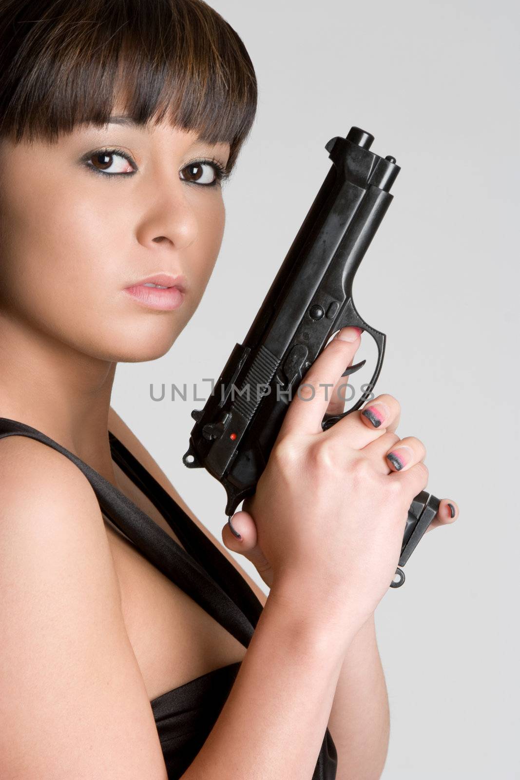 Young asian woman holding gun