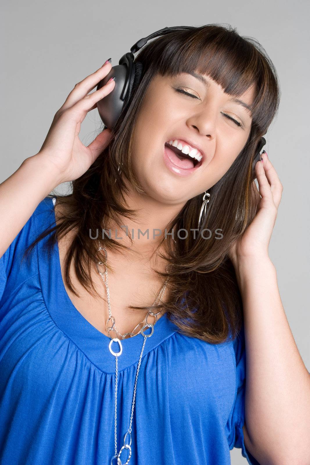 Singing asian girl wearing headphones