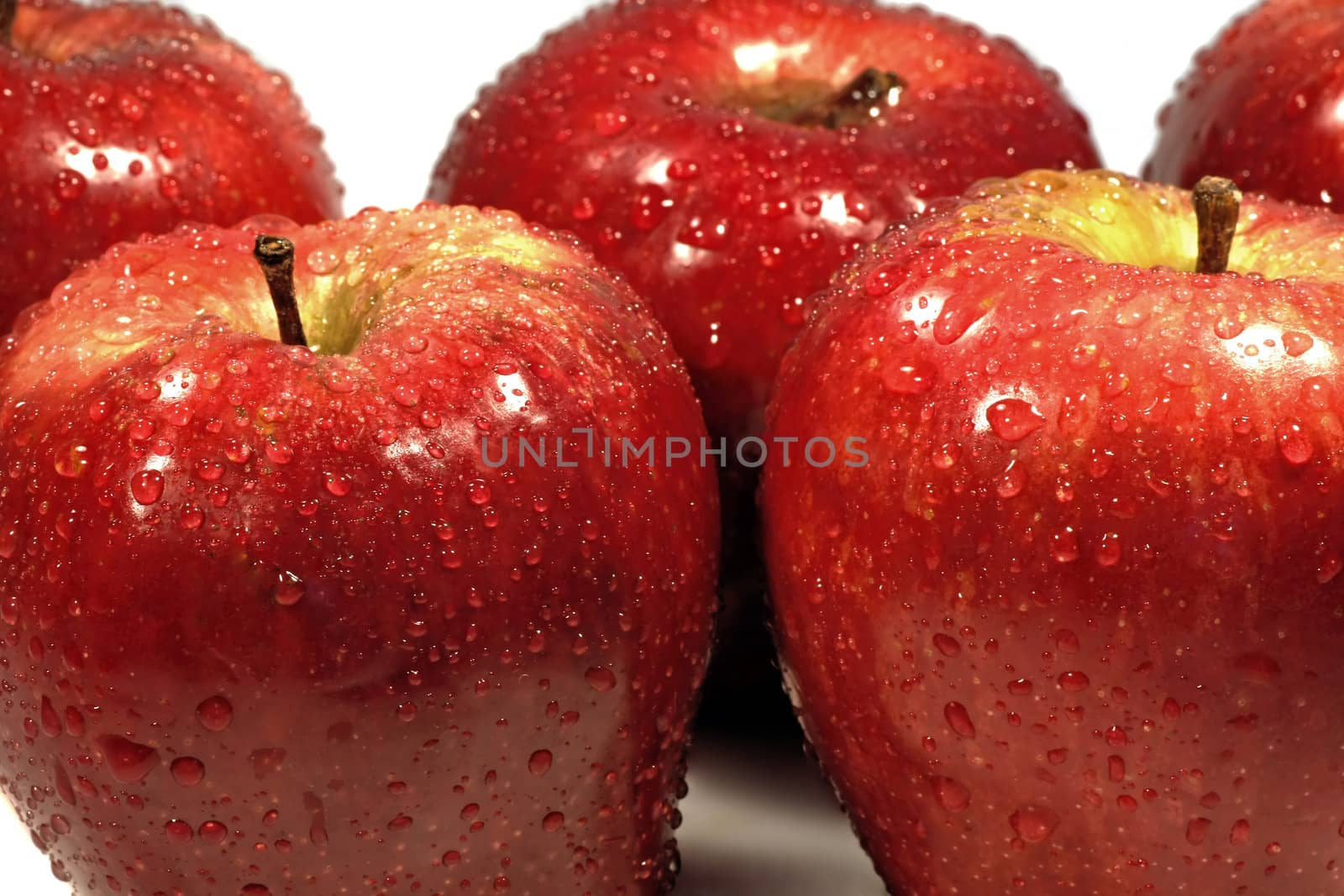 Bunch of red apples isolated on a white background, with drops of water.