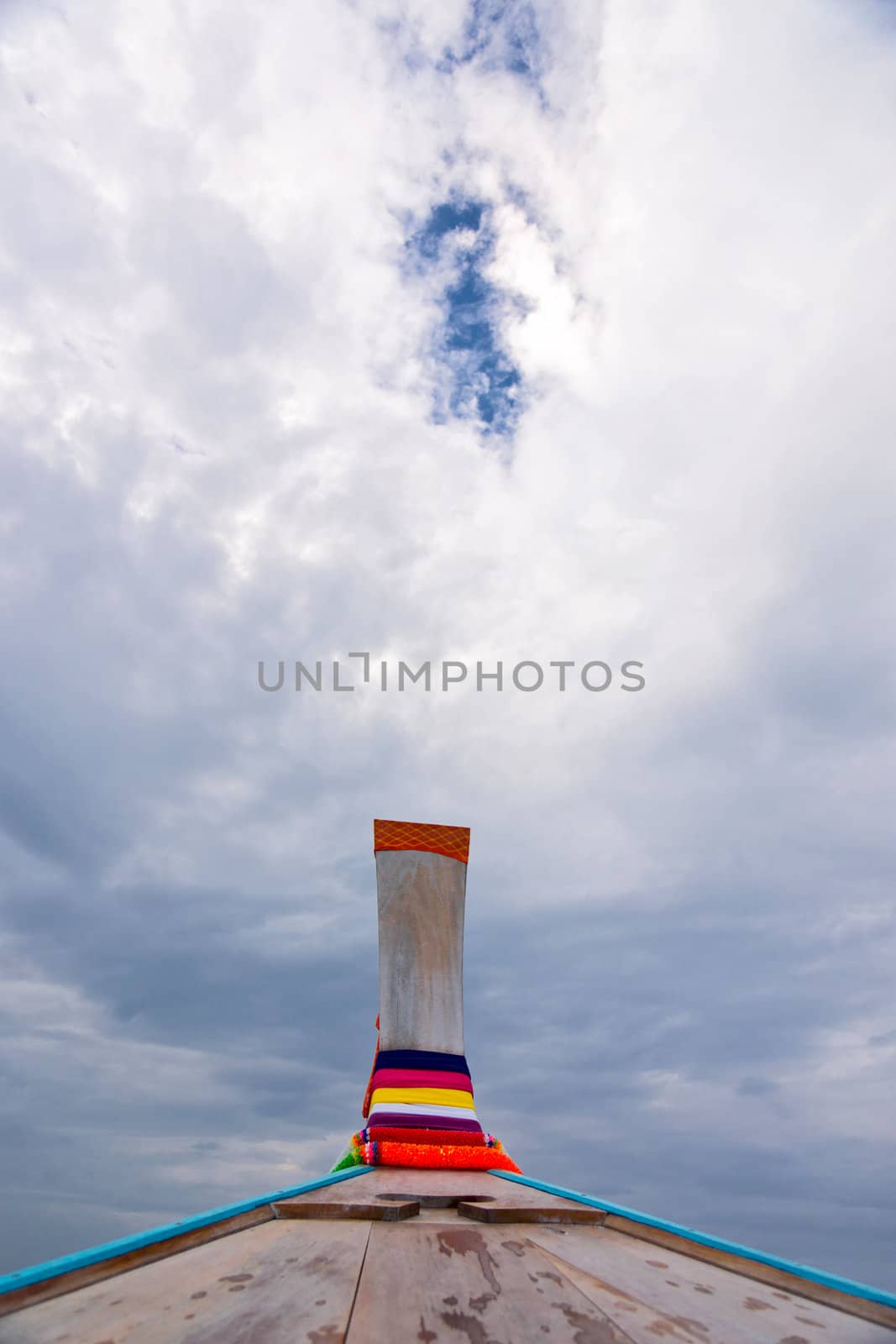 Nose of wooden boat decorated with ribbons