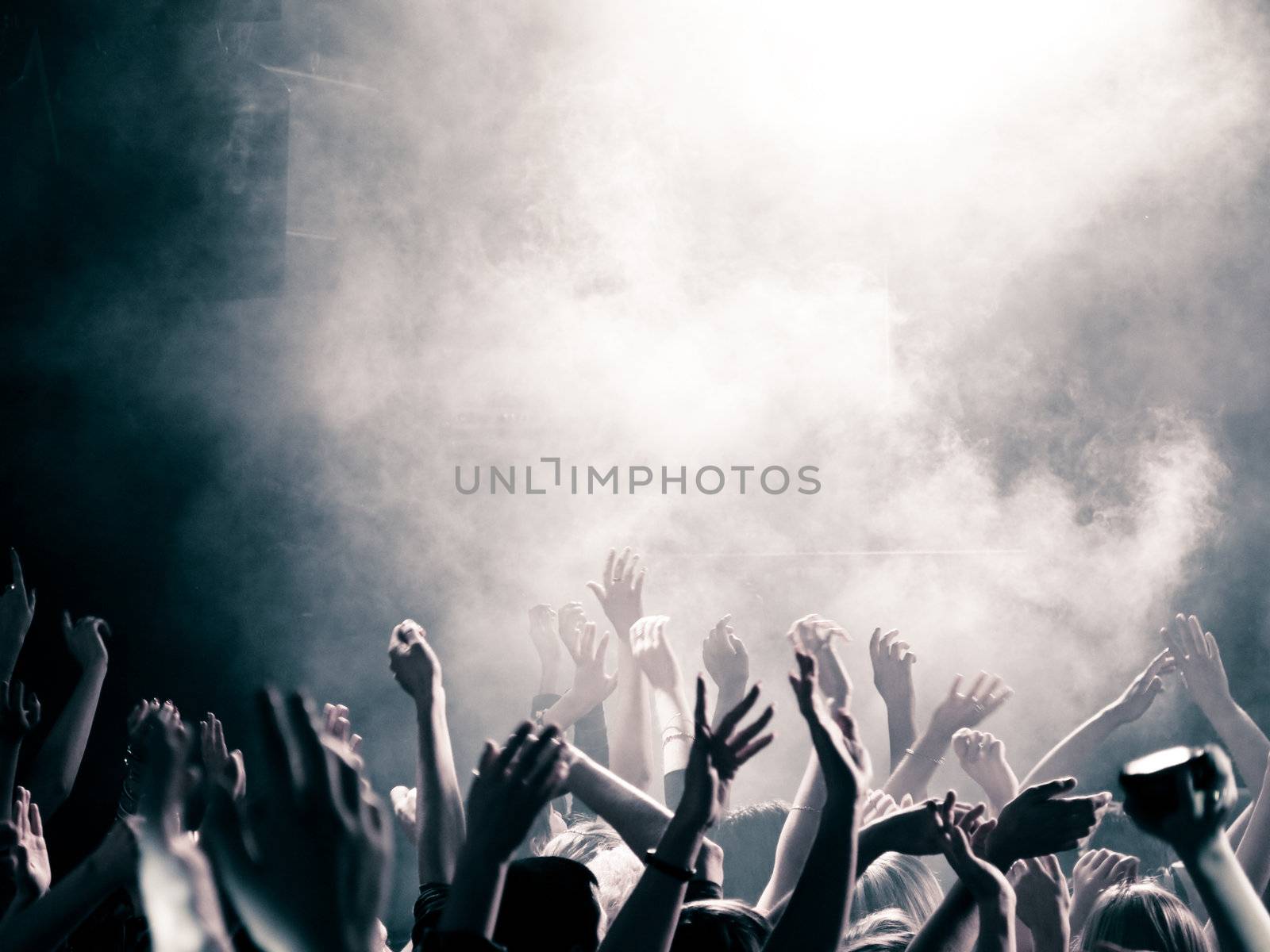 Concert crowd with hands up, toned