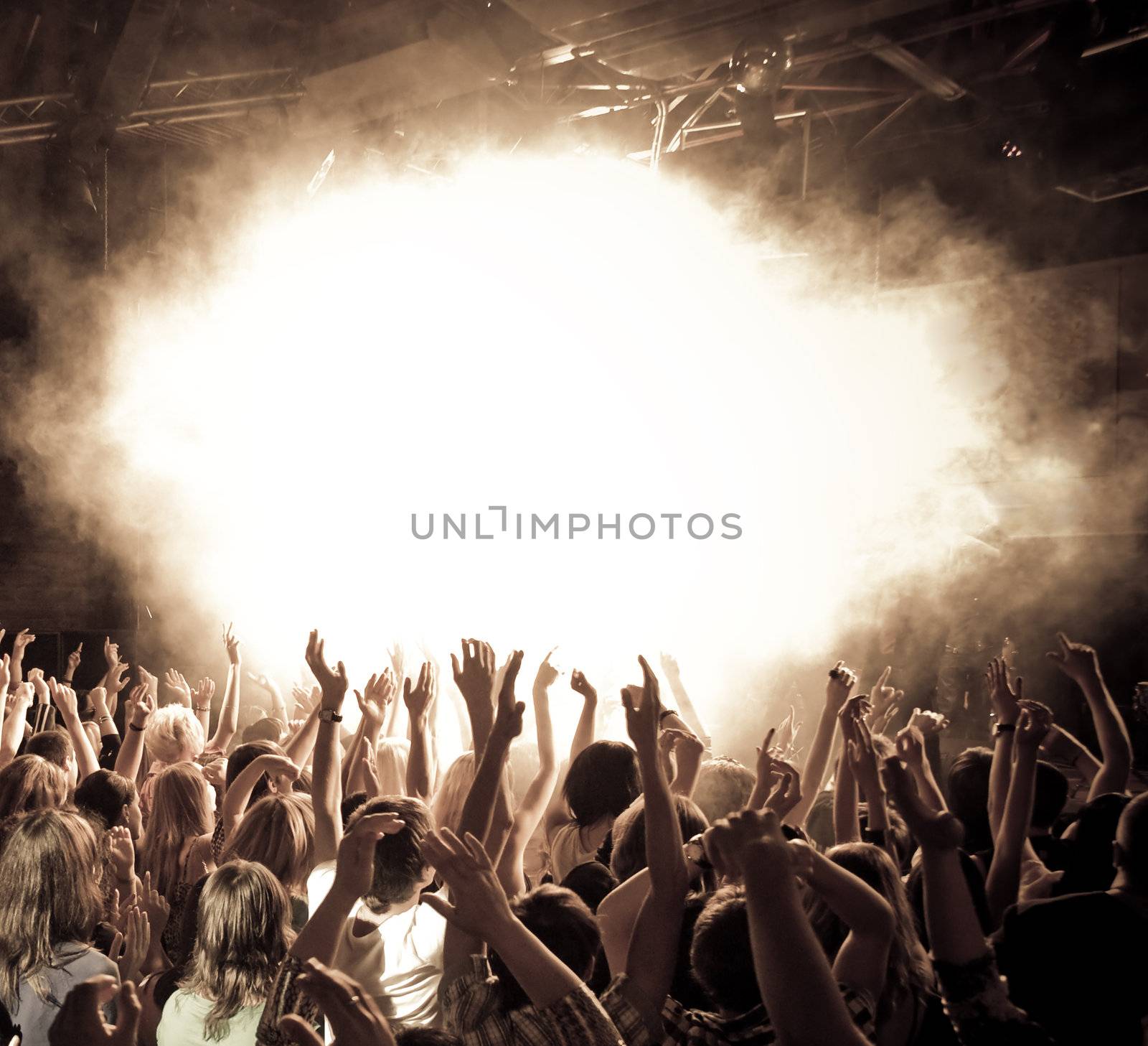 Crowd at a concert waving hands