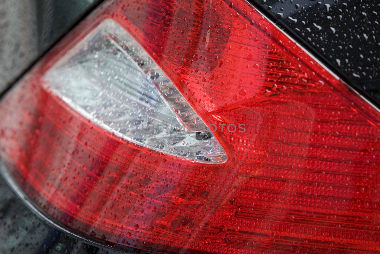 Close-up of tail light of car for sale in showroom