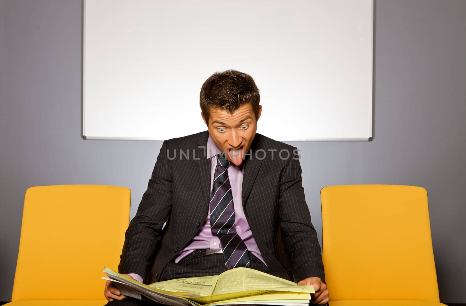 Businessman shocked while reading newspaper