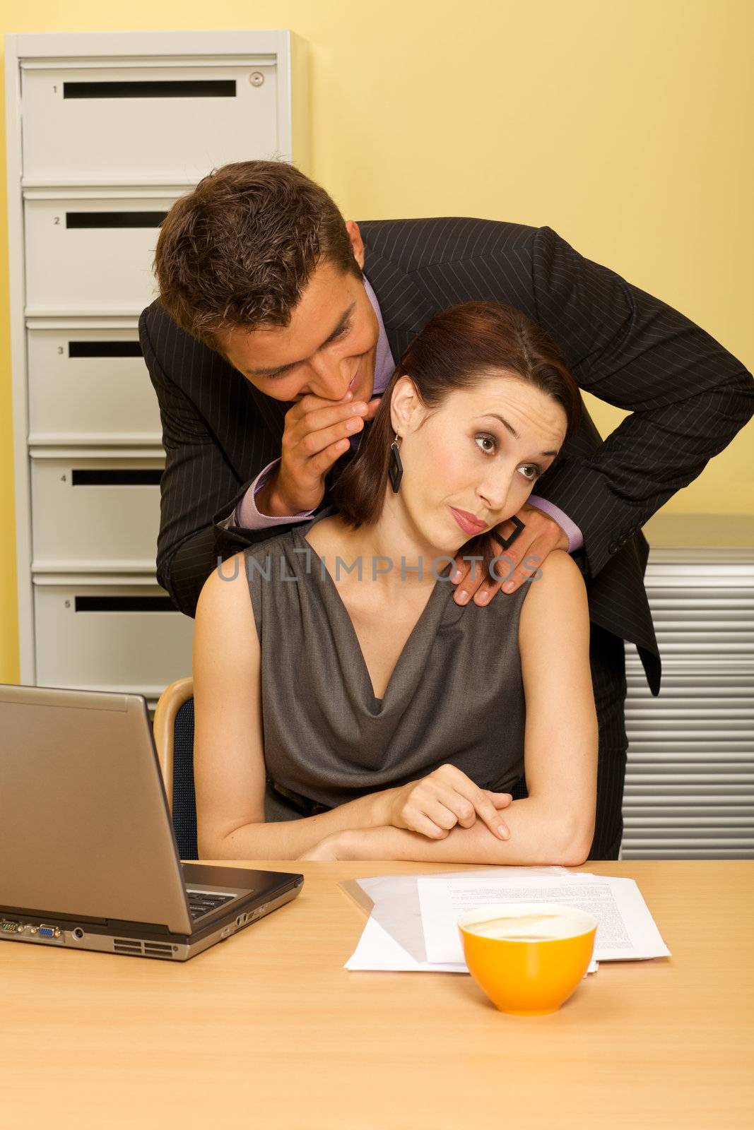 Businessman flirting with businesswoman in office