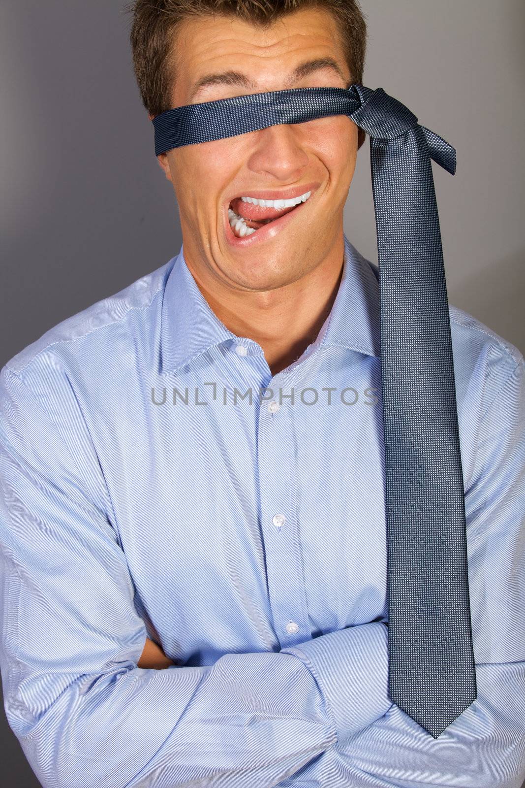 Blindfolded businessman making face