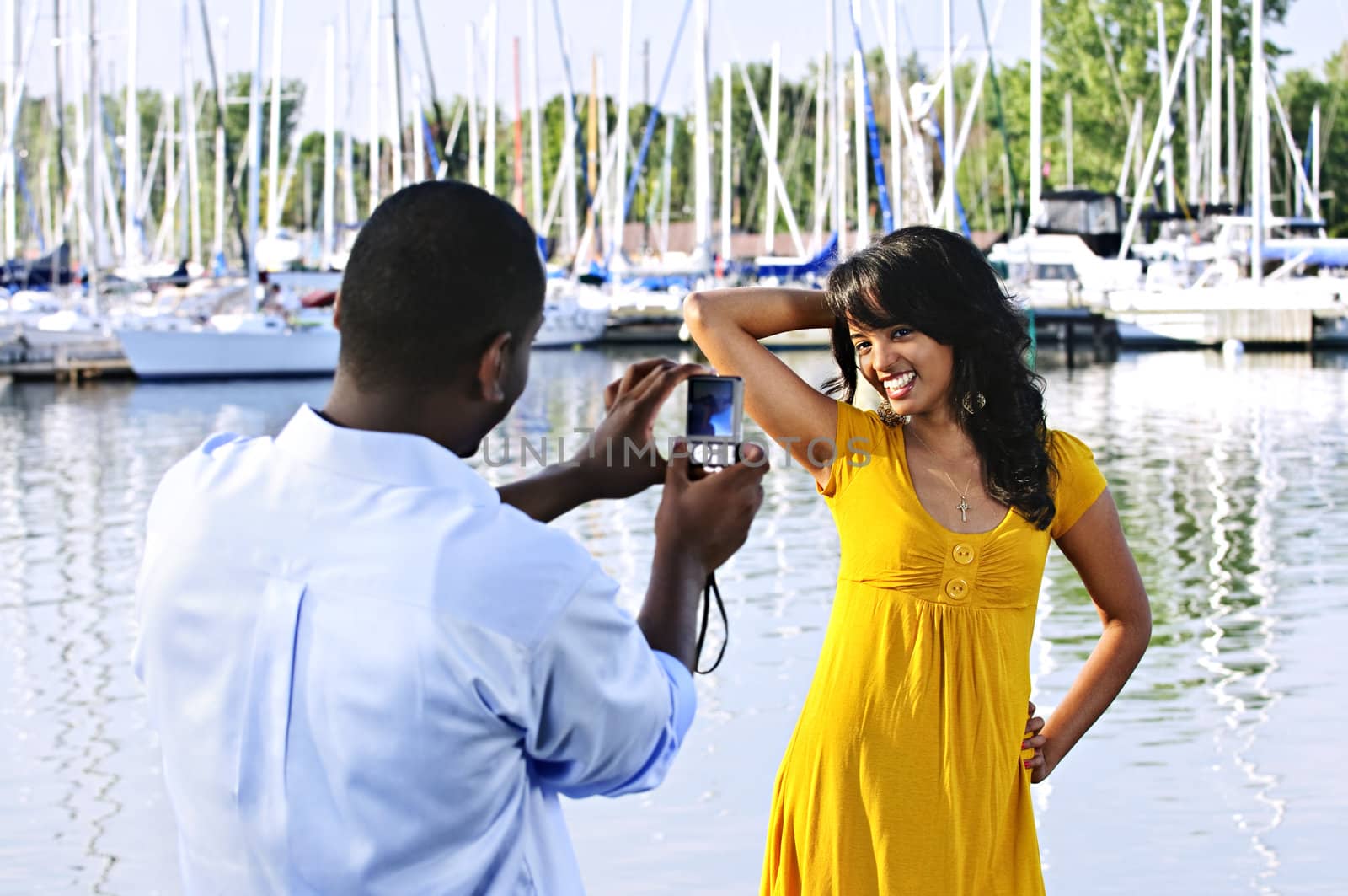 Beautiful woman posing for vacation photo at harbor