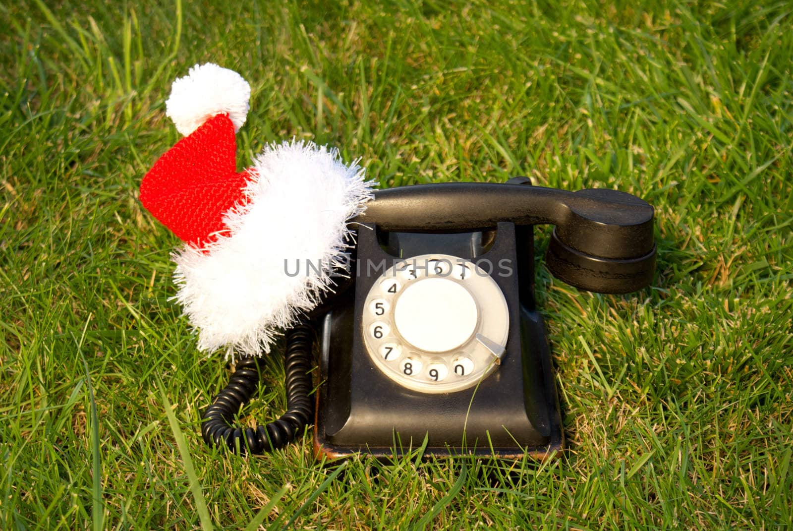 Old fashioned black telephone with Santa's hat