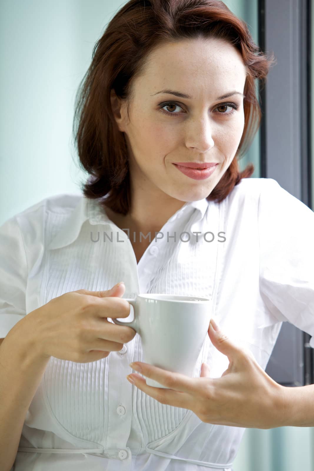 Young woman drinking coffee in the morning