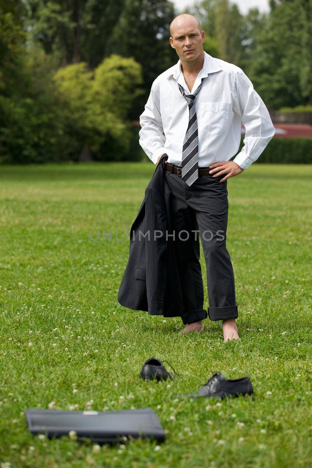 Portrait of businessman in contemplation standing in park