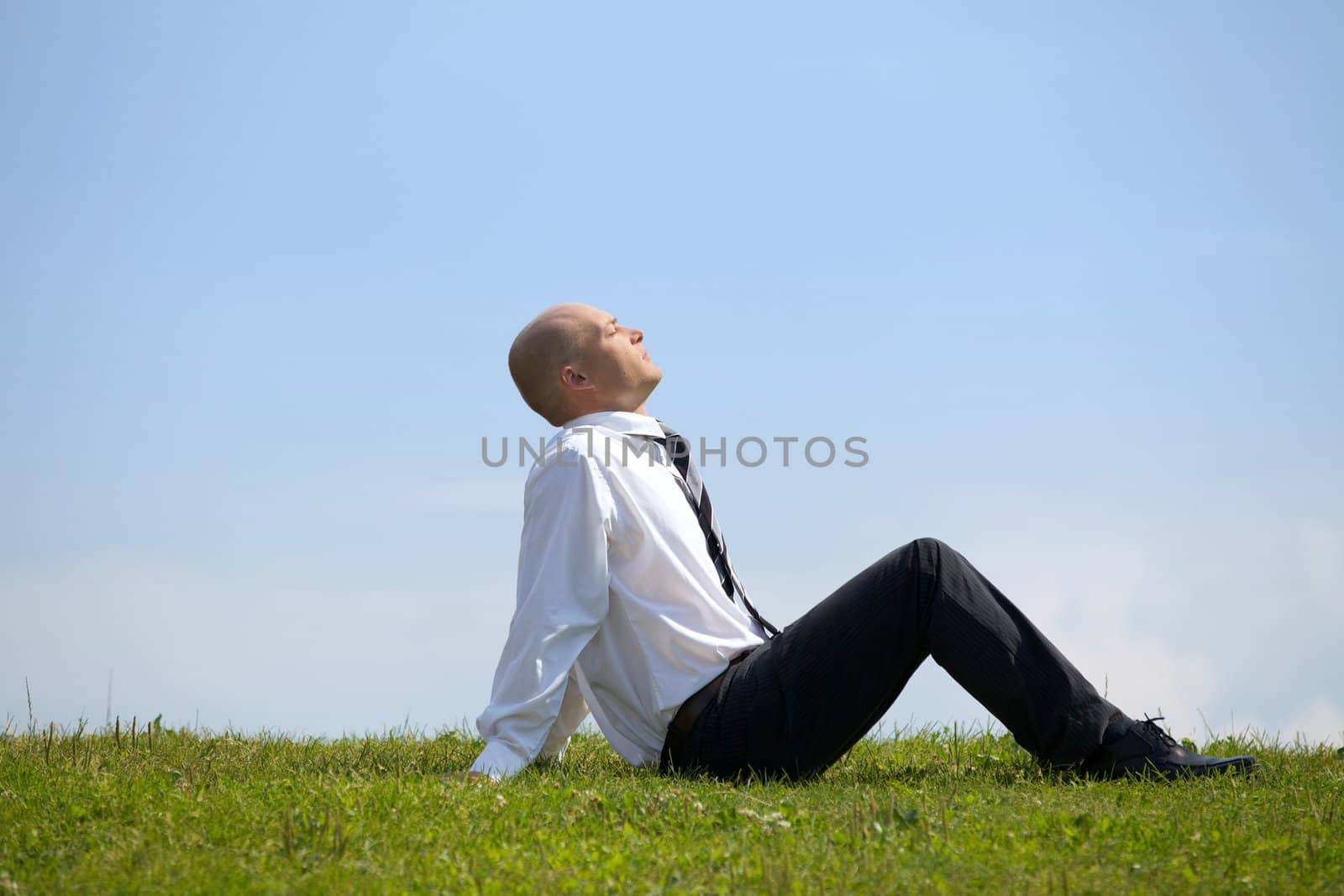 Businessman contemplating in park