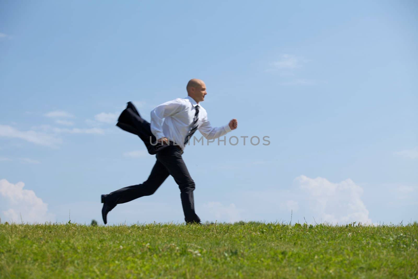 Businessman running in park