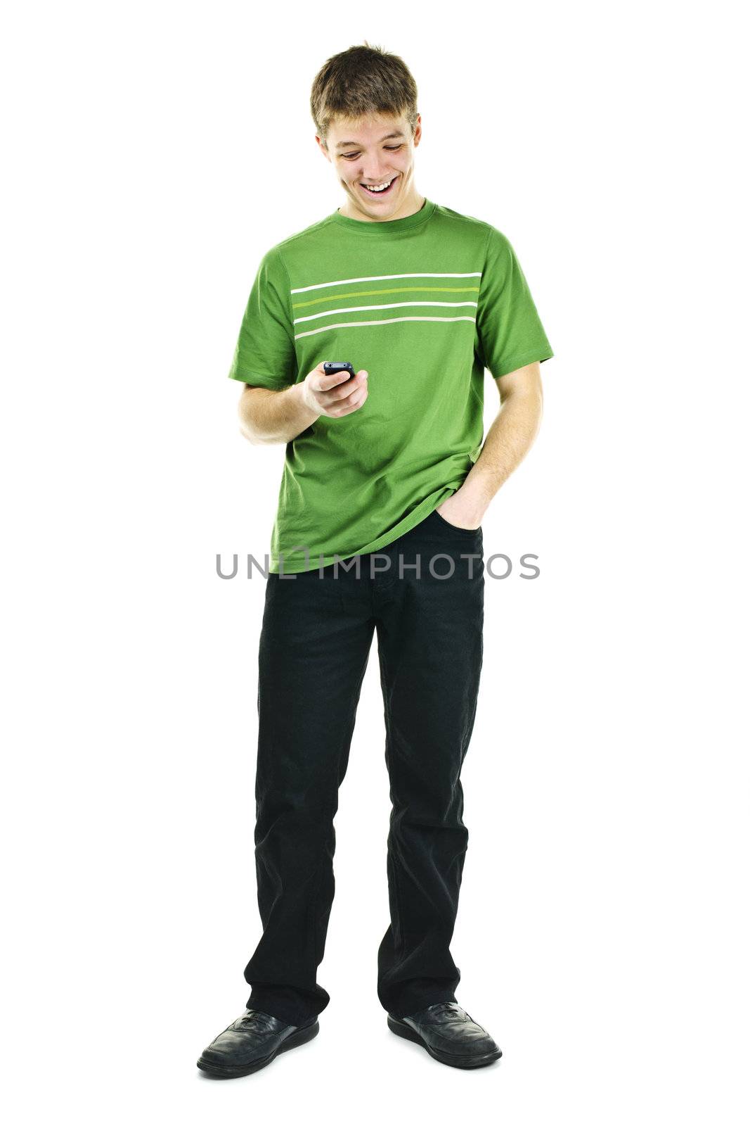 Happy young man texting on cellphone standing full body isolated on white background