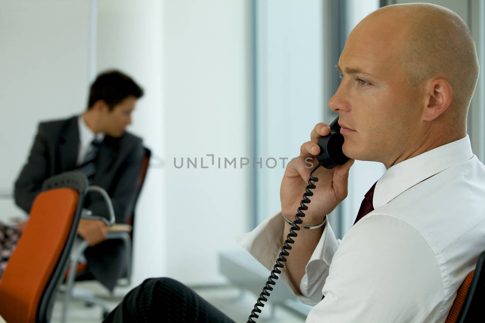 portrait of young confident caucasian businessman talking on pho