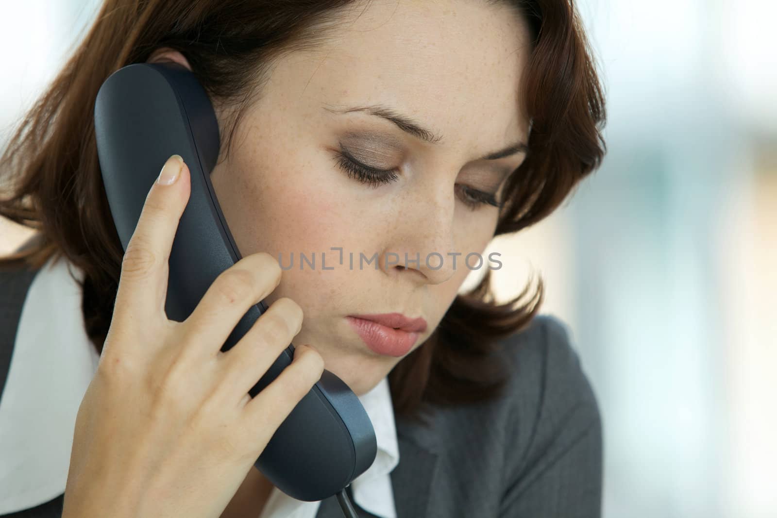 portrait of young confident caucasian businesswoman talking on phone