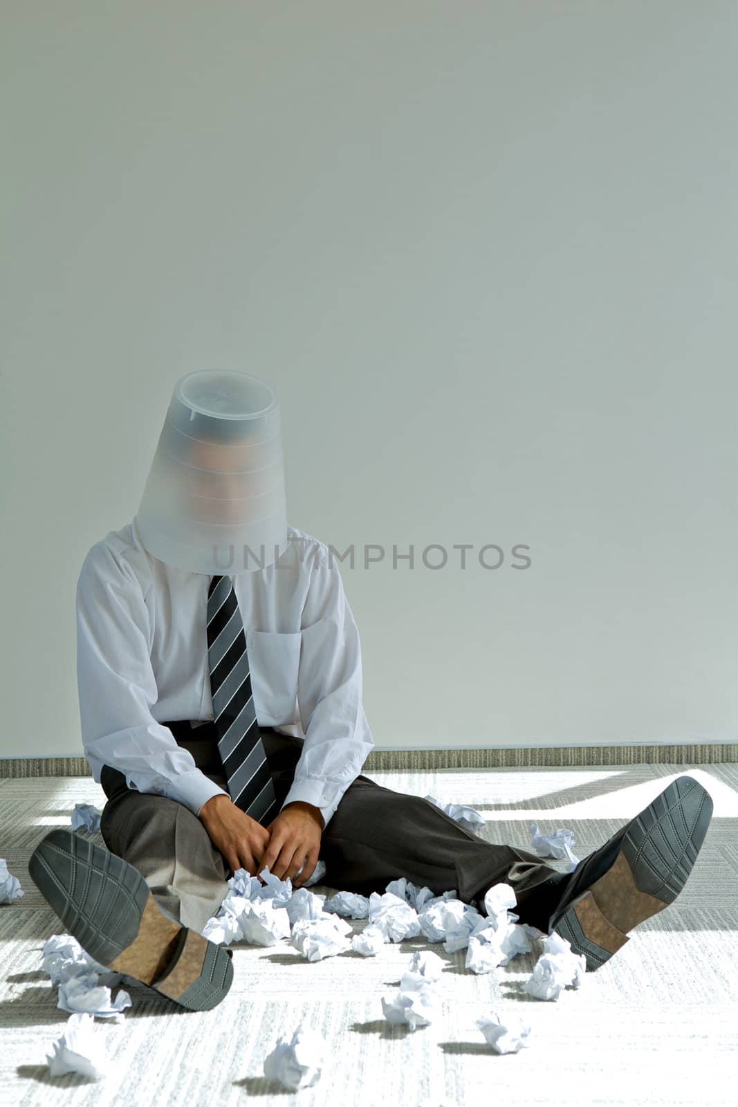 young caucasian businessman with trash bin on his head