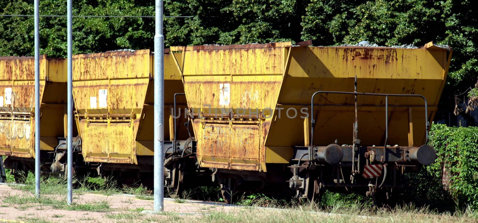 Yellow cargo train wagons at a station