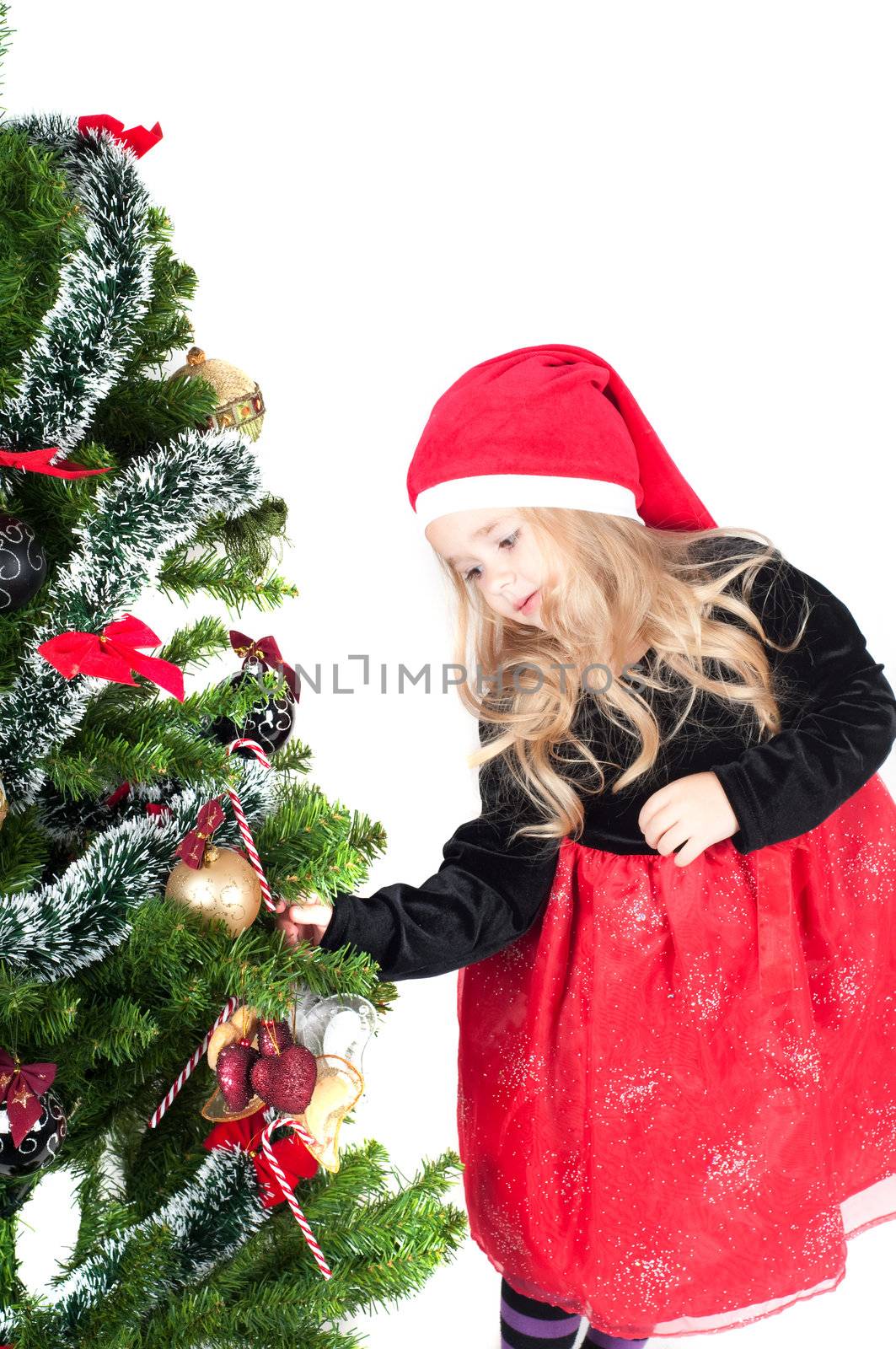 Beautiful baby girl dressed up for Christmas isolated in white