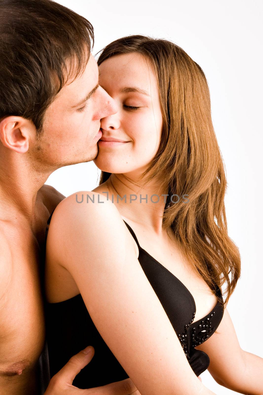 Young adult couple in the studio hugging