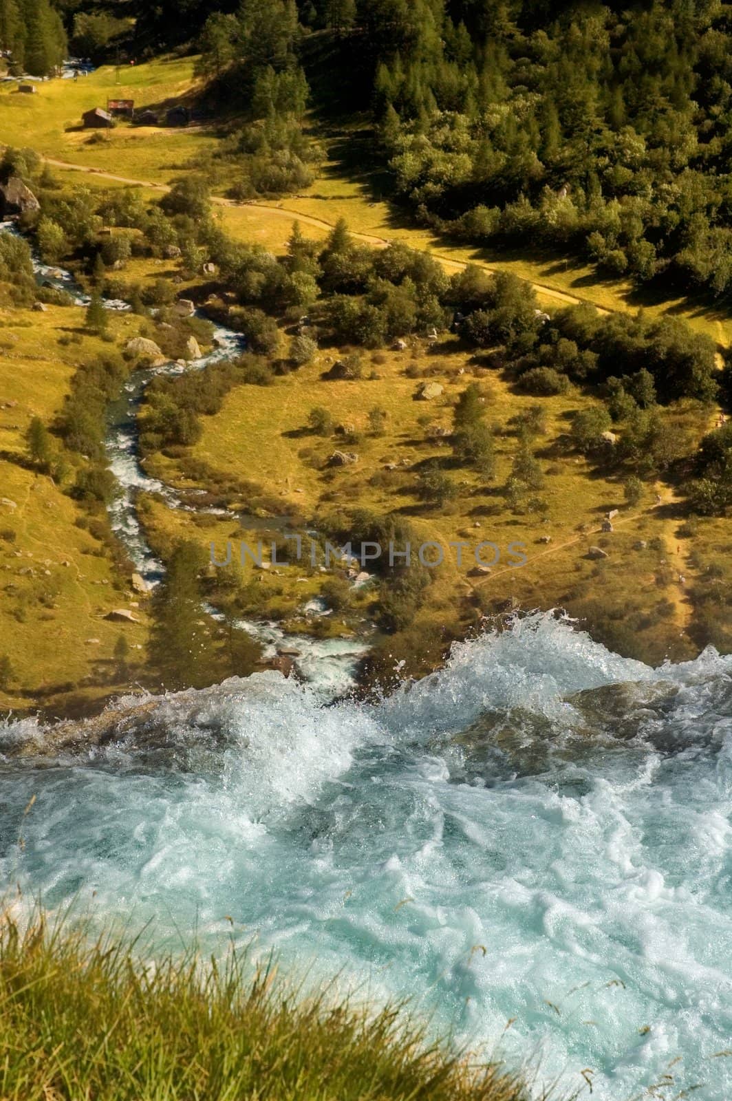 Waterfall overlooking alpine landscape