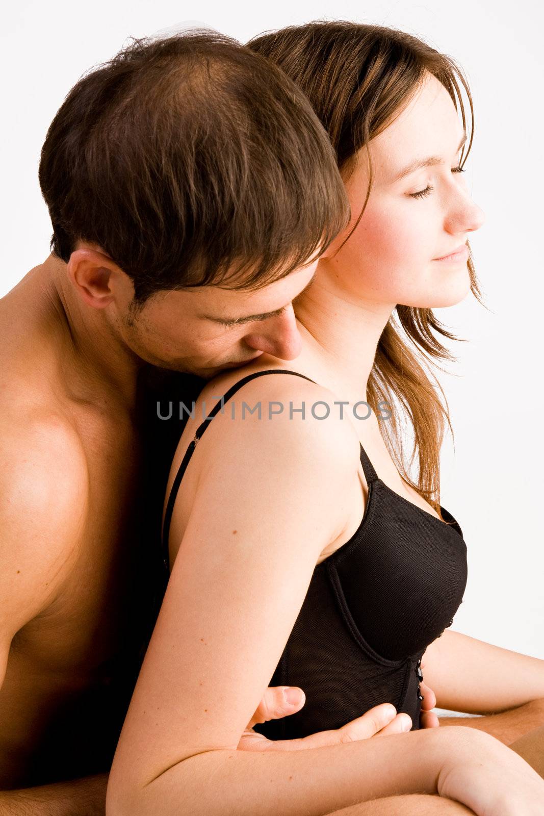 Young adult couple in the studio hugging