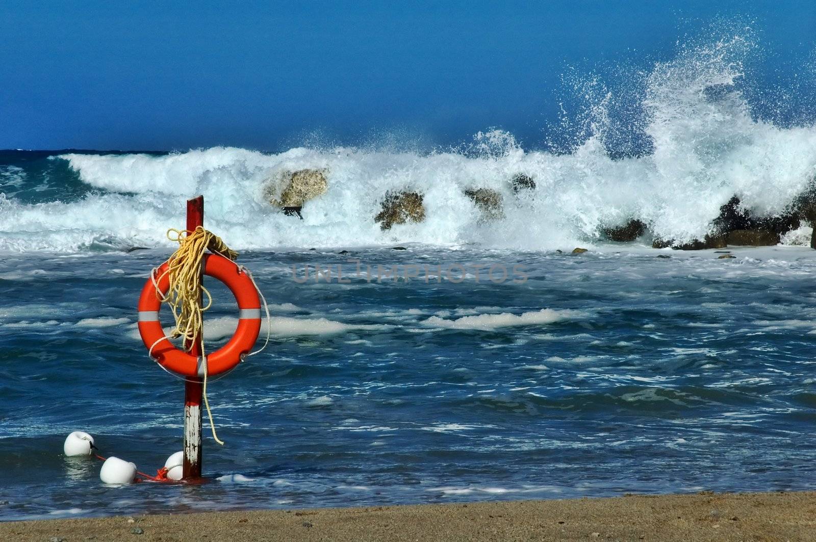 Beach life saver with rough sea and big waves in the background