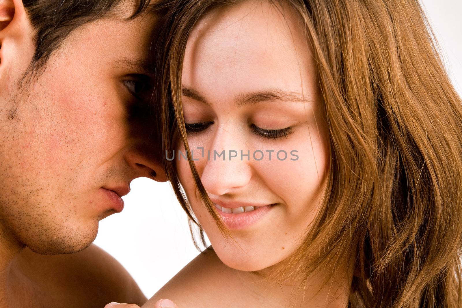 Young adult couple in the studio hugging
