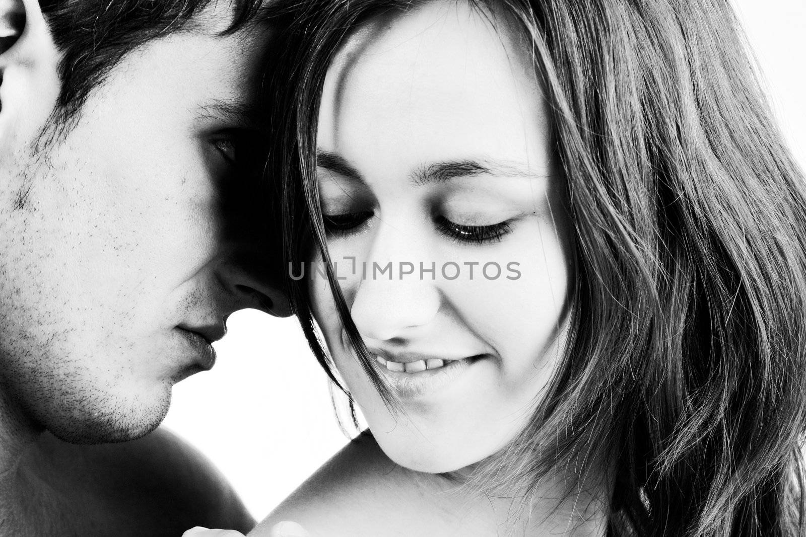 Young adult couple in the studio hugging