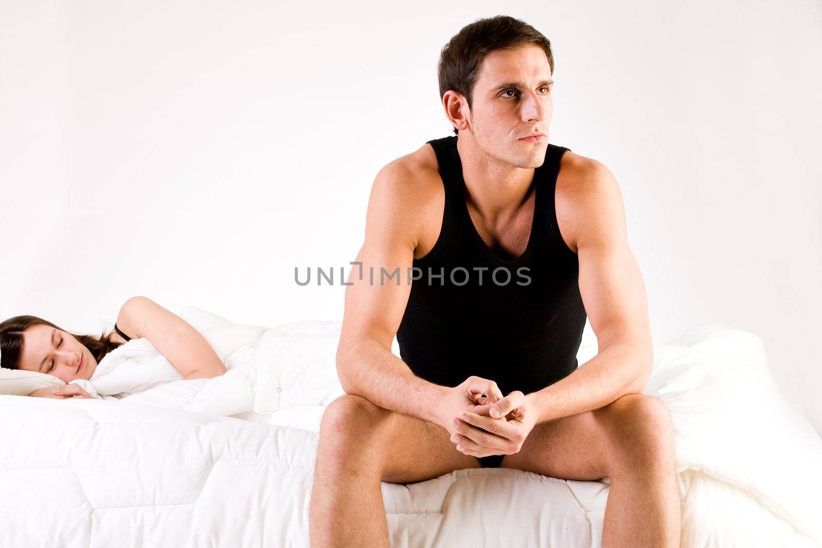 Young adult couple in the studio on a bed