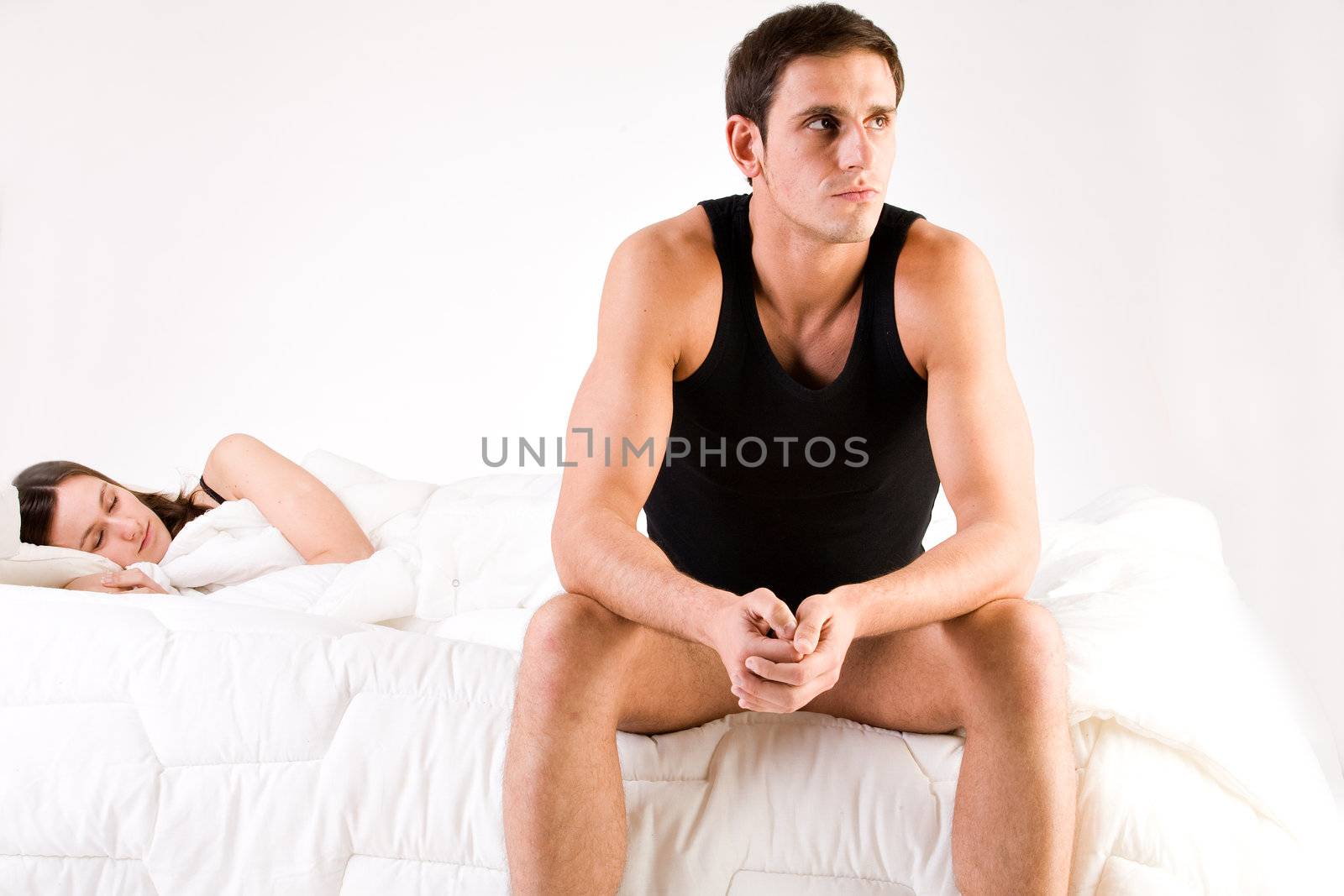 Young adult couple in the studio on a bed