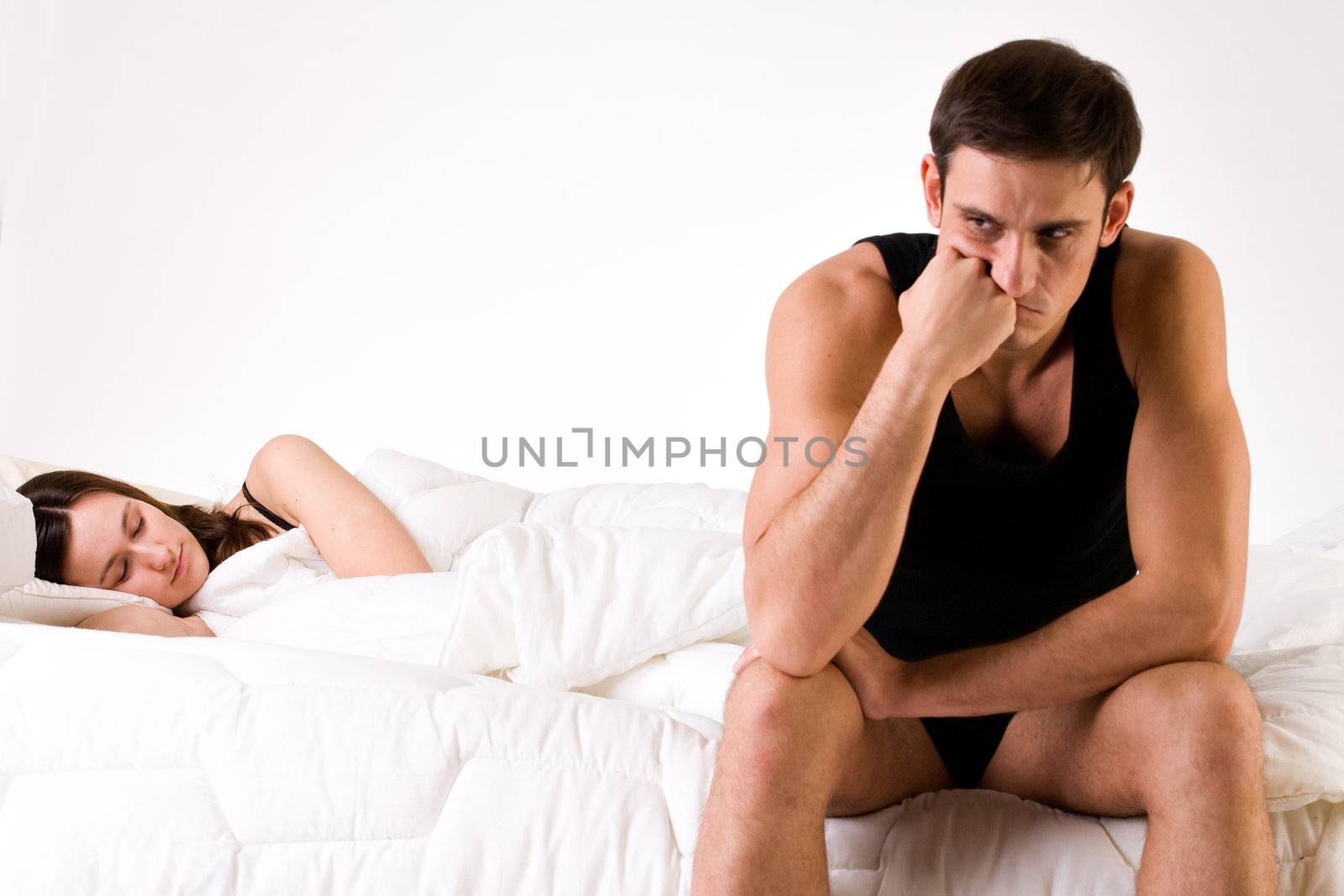 Young adult couple in the studio on a bed