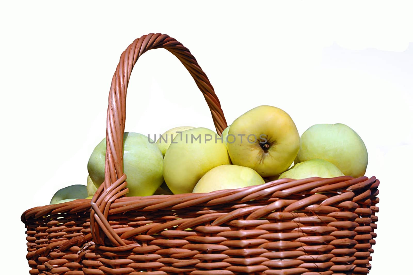 Basket with green apples in a garden on a white background 