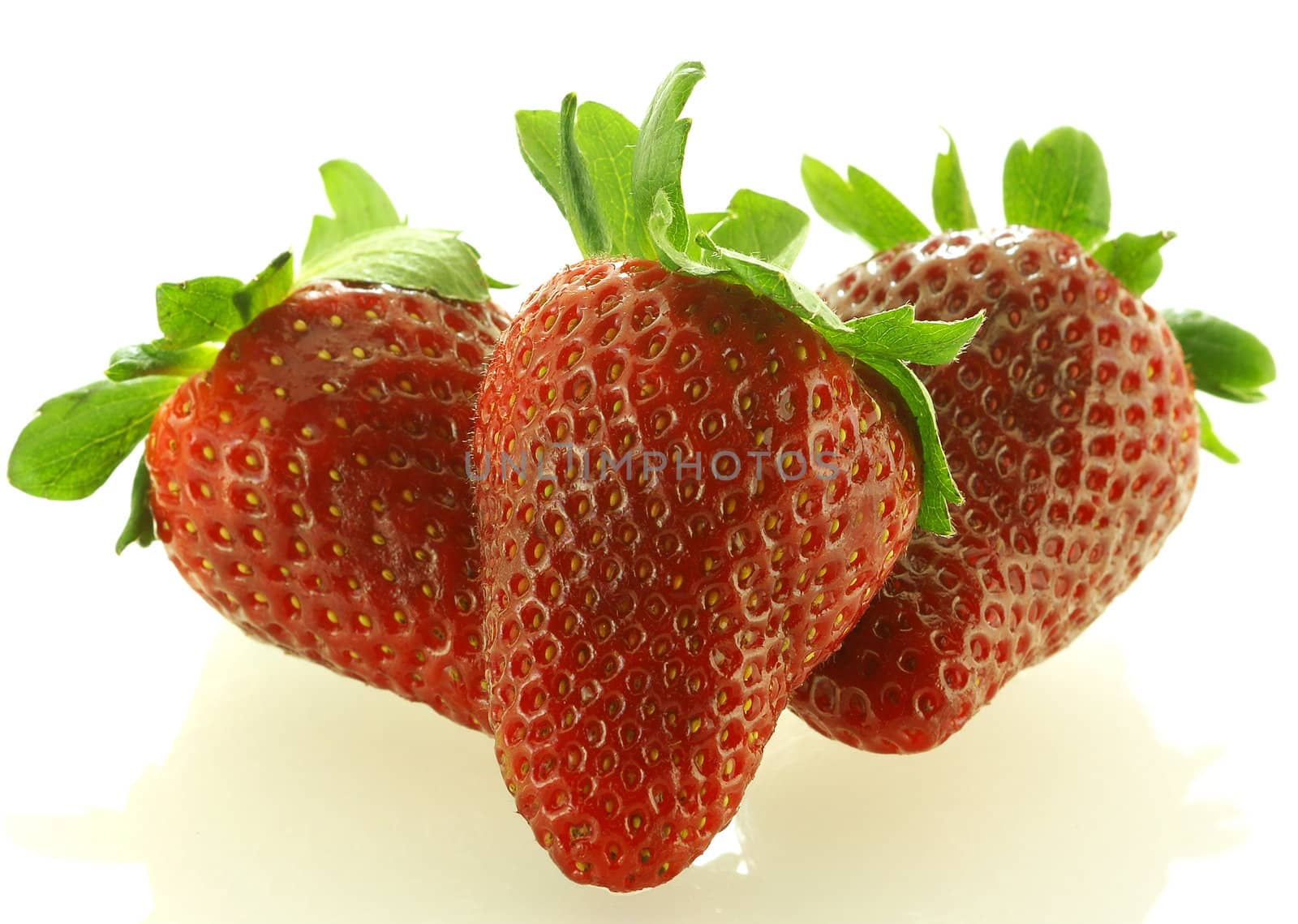 Close up shot of three ripe strawberry over white background        