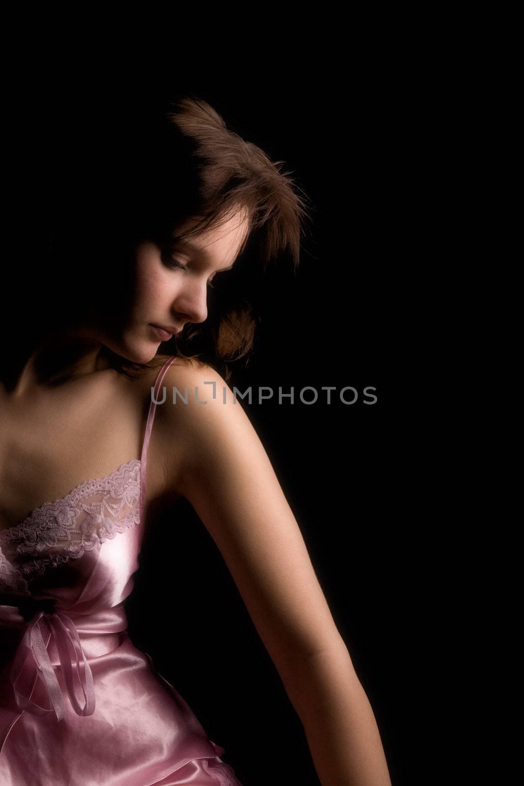 Studio portrait of a woman in luxurious lingerie in a low key setting