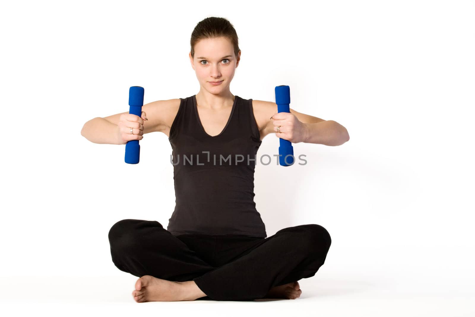 Young girl is sporting in the studio on a white background