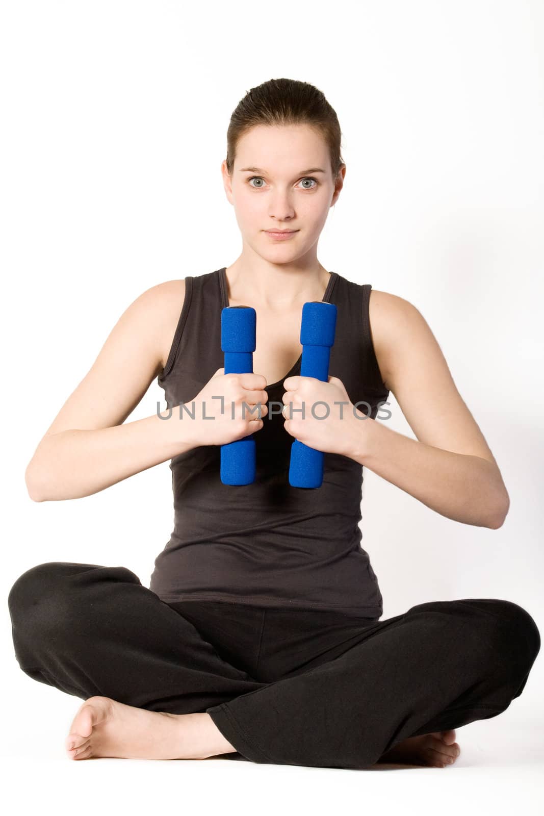 Young girl is sporting in the studio on a white background