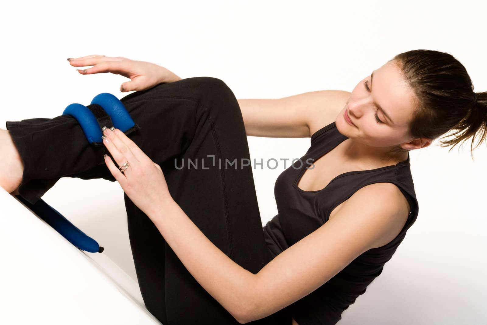 Young girl is sporting in the studio on a white background