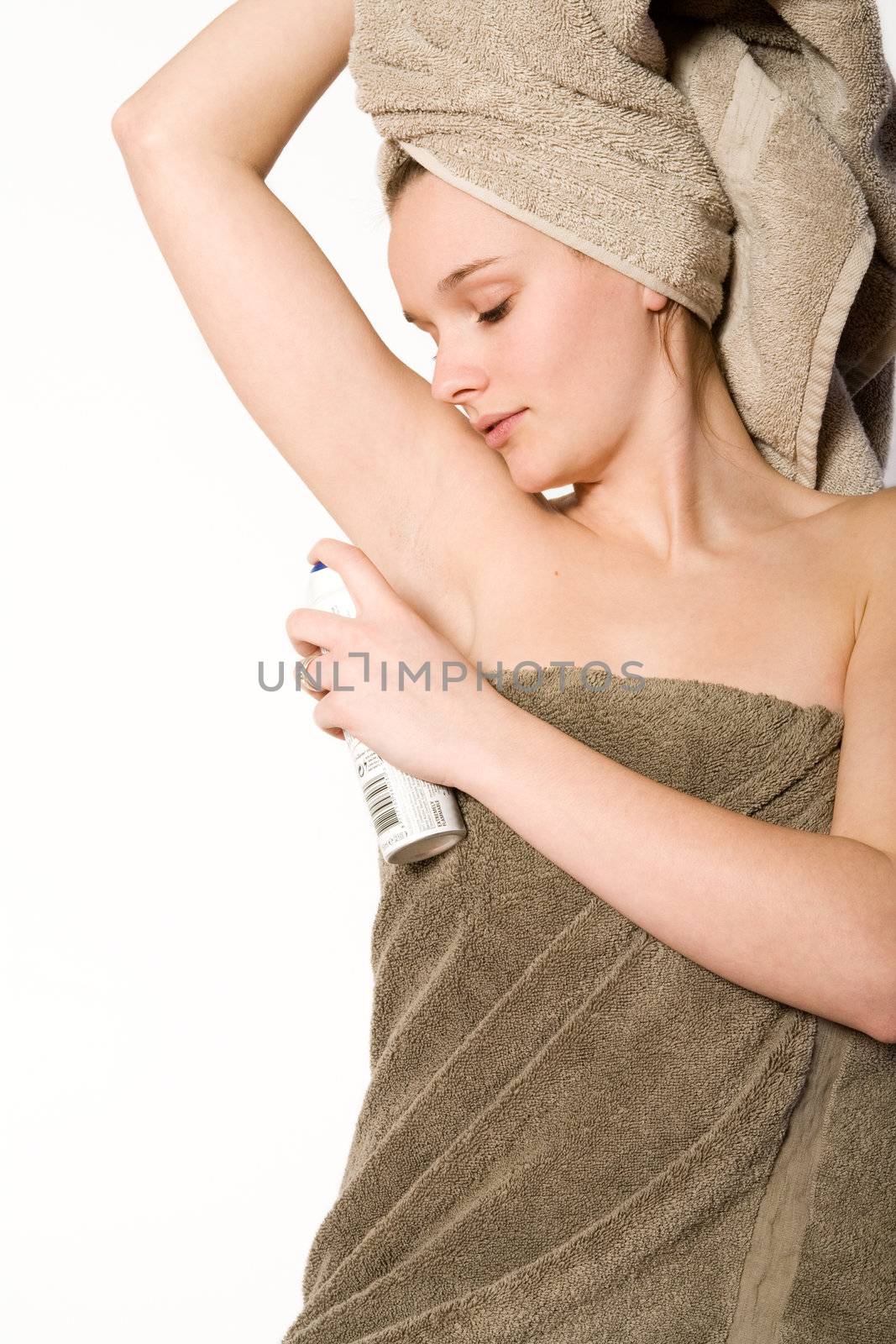 Young woman in towel on a white background grooming