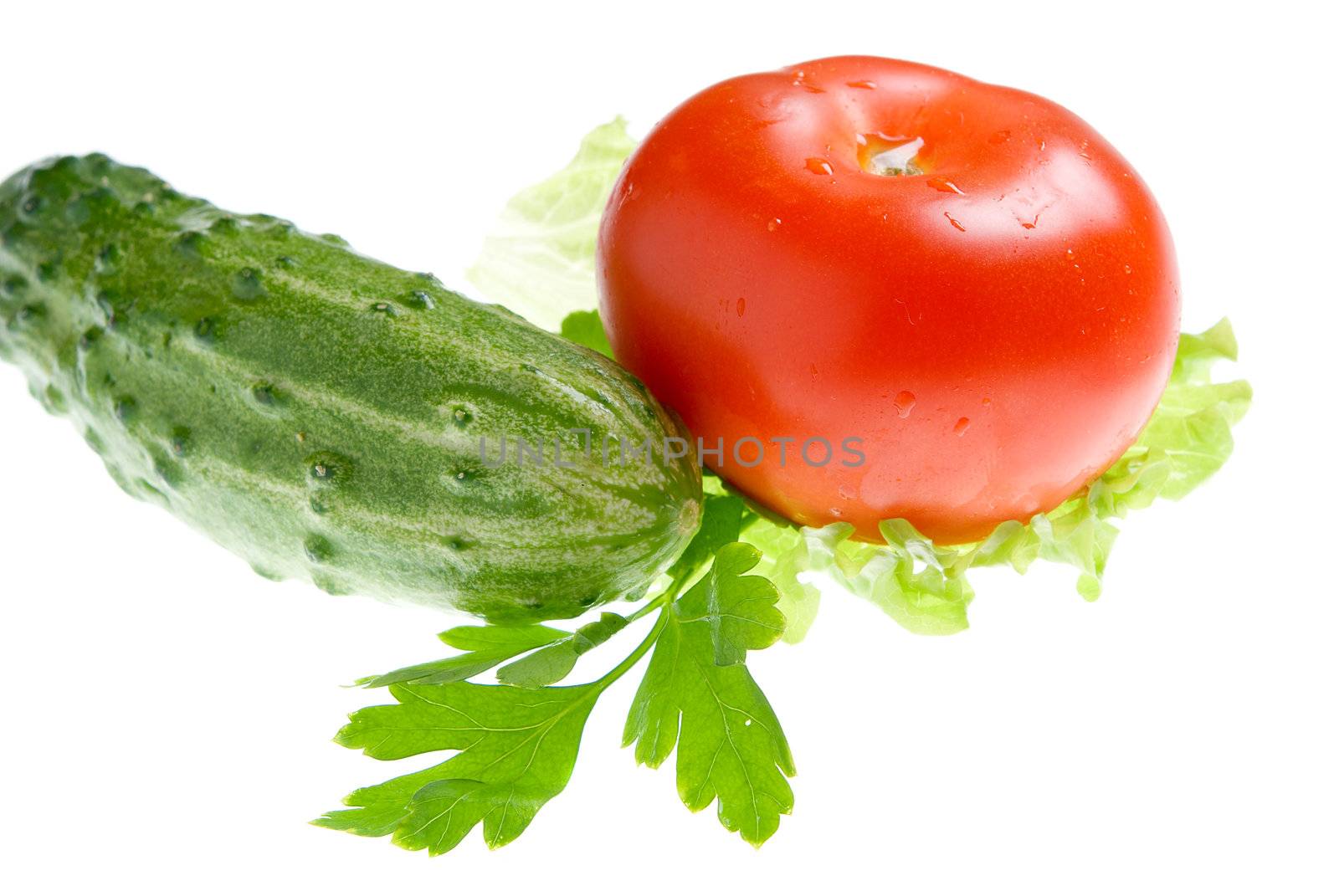 Spring vegetables. A tomato, a cucumber, salad. Useful vitamins