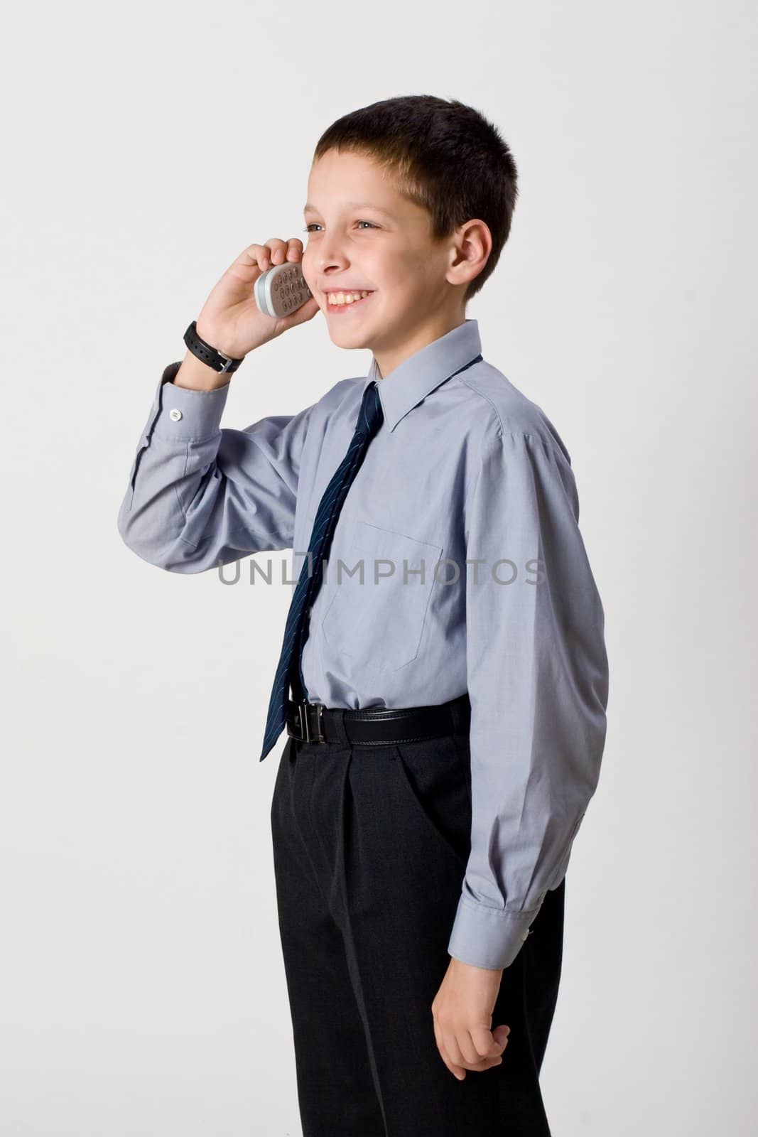 young boy talking by cell phone