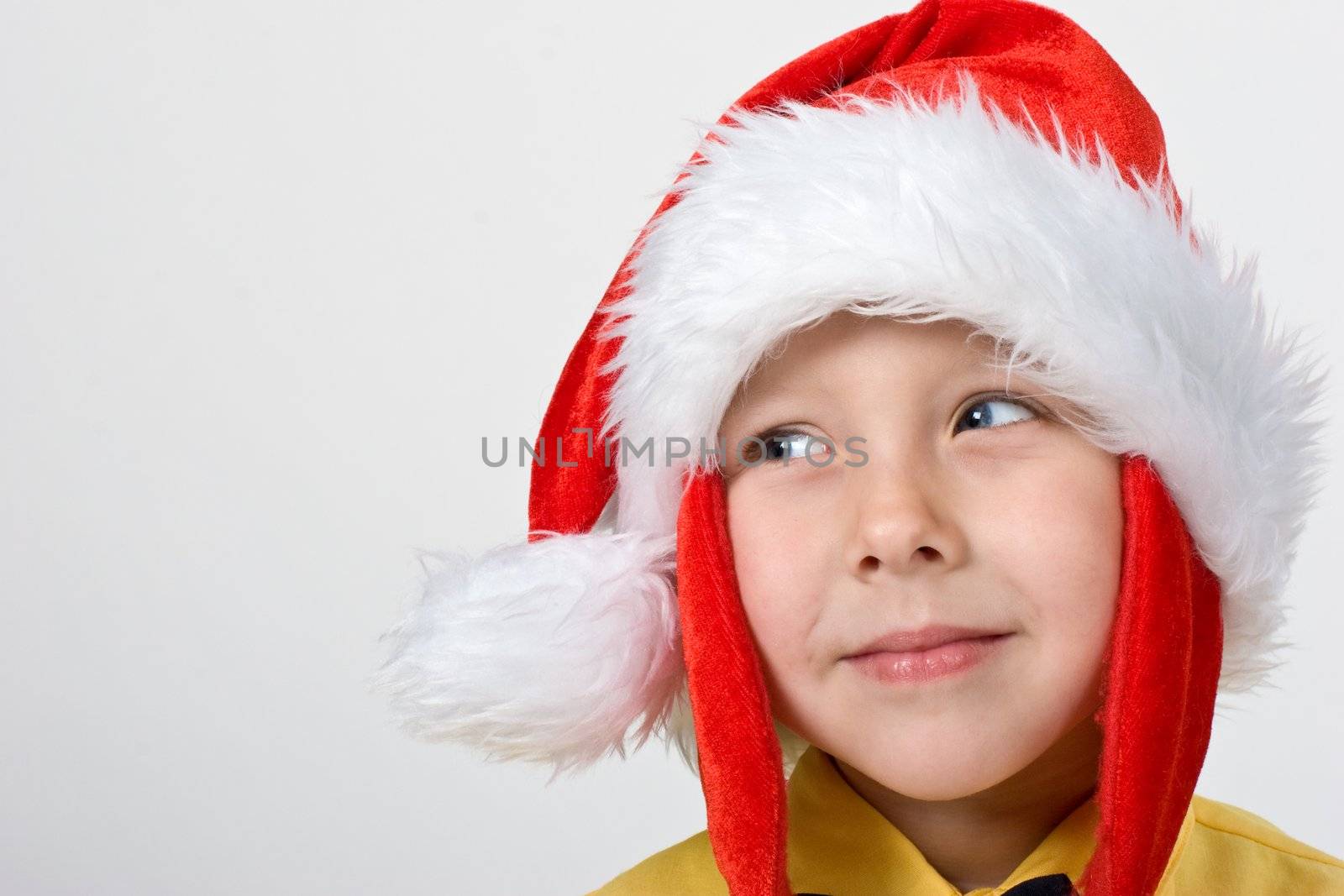 portrait of little boy in the santa`s cap