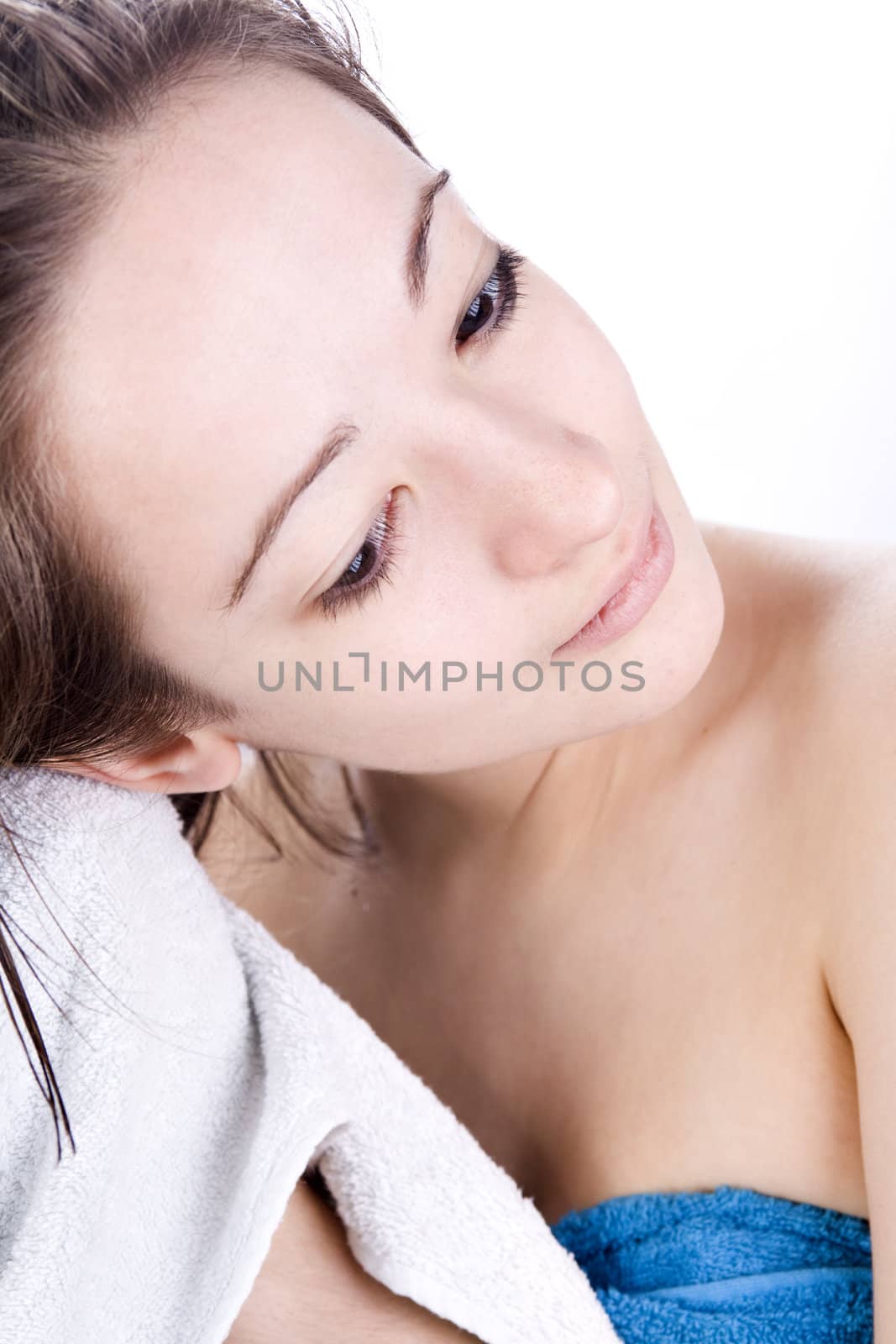 Studioshot of young woman drying her hair