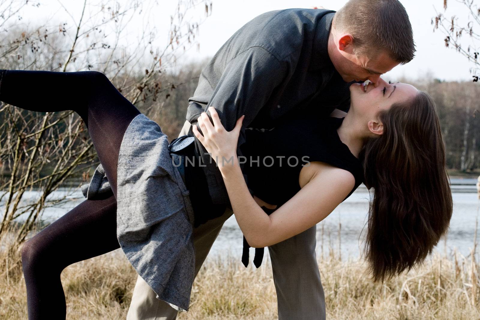 Young loving couple are hugging in the park